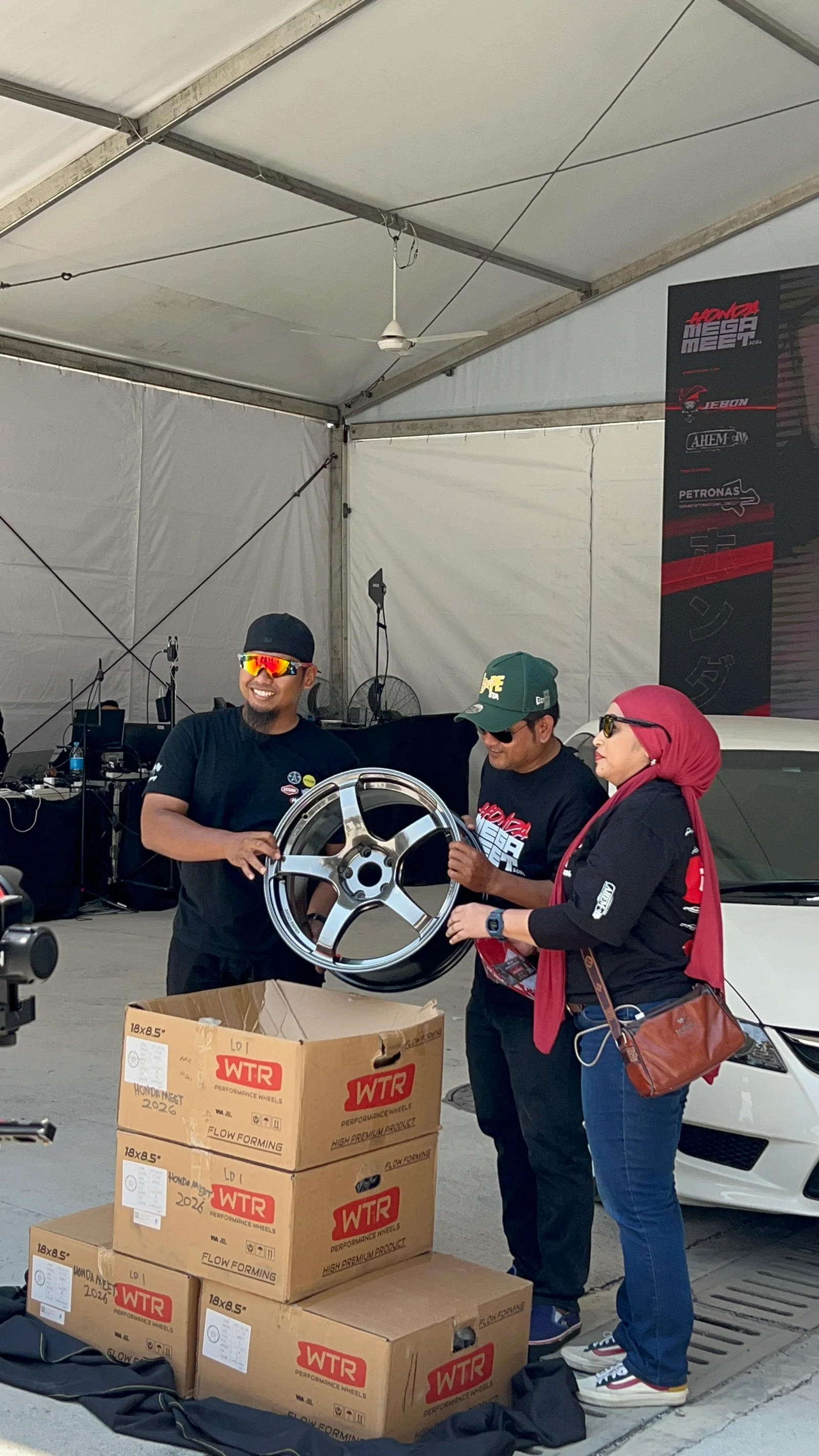 ASG team presenting a polished WTR wheel during a community event