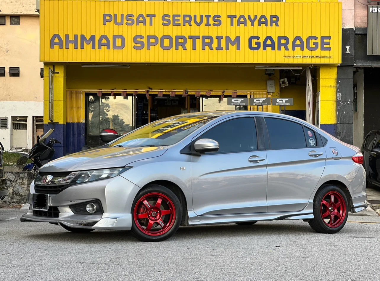 Silver Honda City with red six-spoke wheels outside ASG
