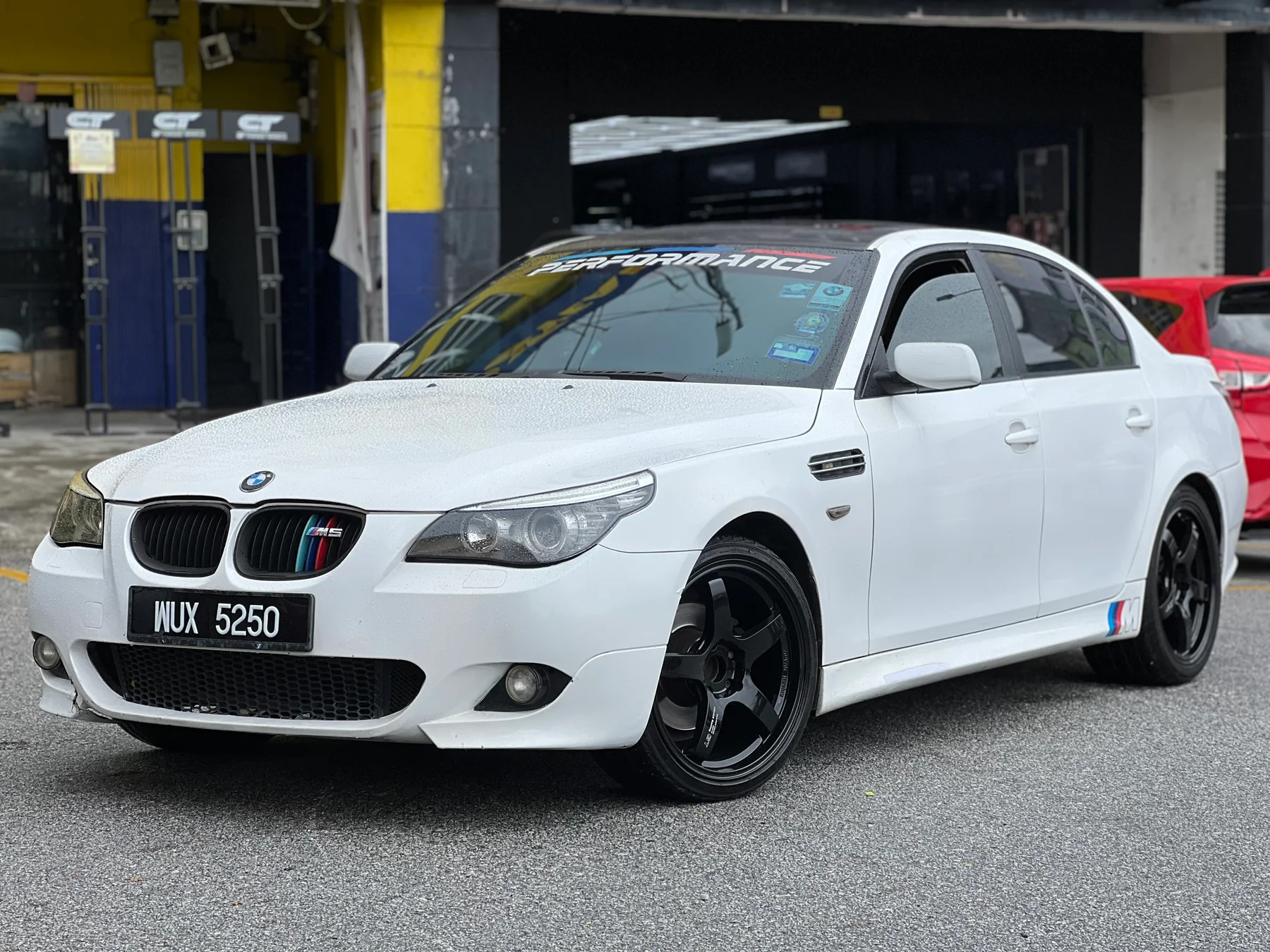 White BMW sedan with dark performance wheels outside ASG