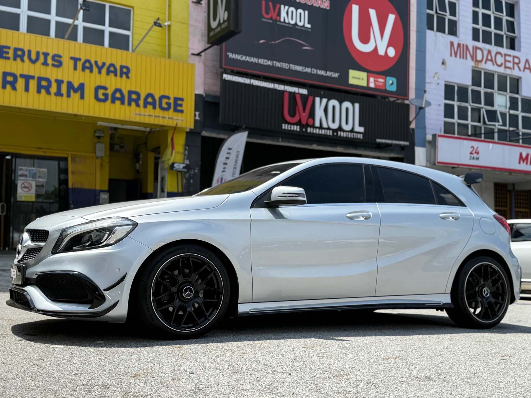Silver Mercedes-Benz sedan with dark multi-spoke wheels outside ASG