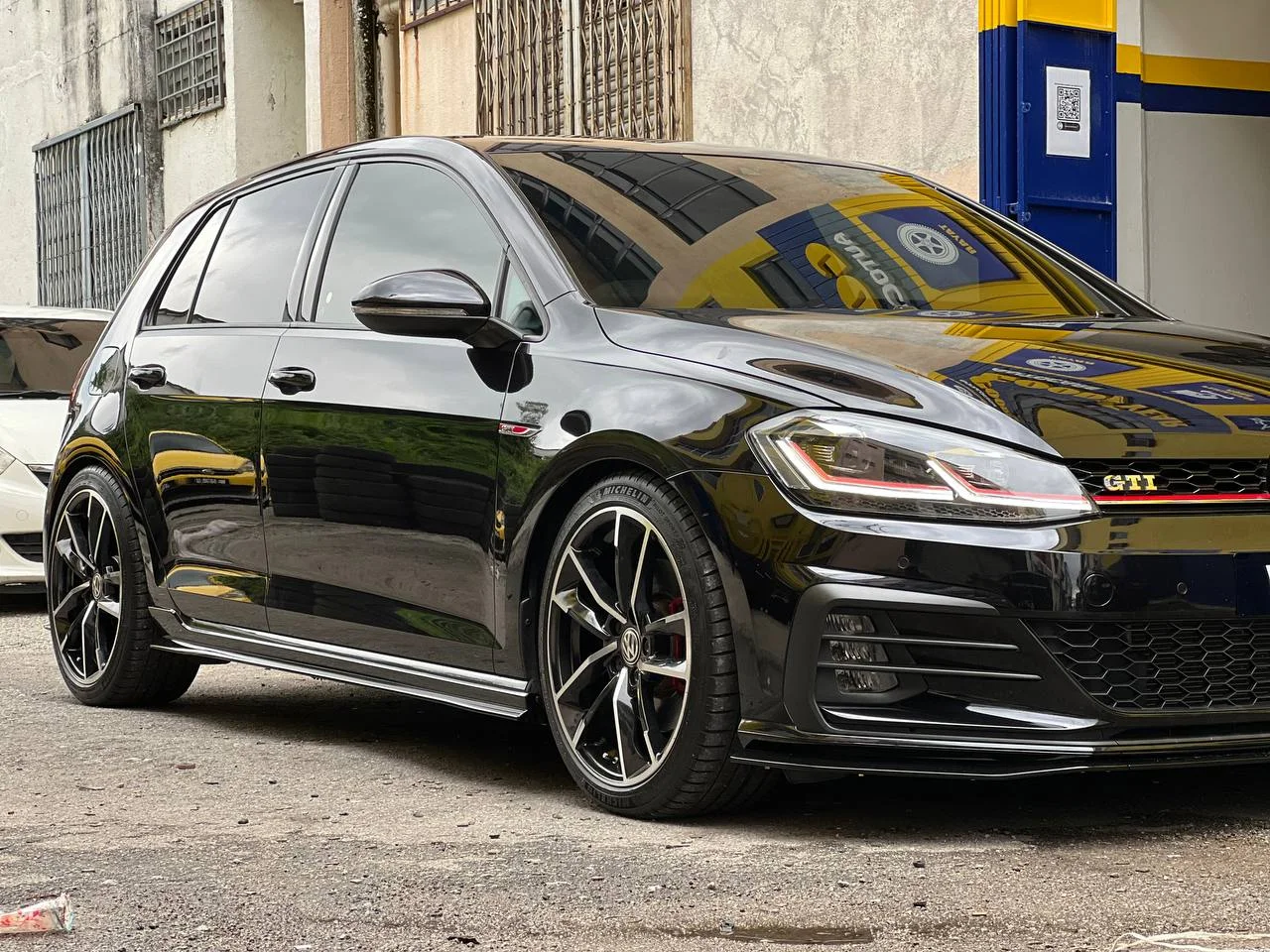Black Volkswagen Golf GTI with black and machined wheels