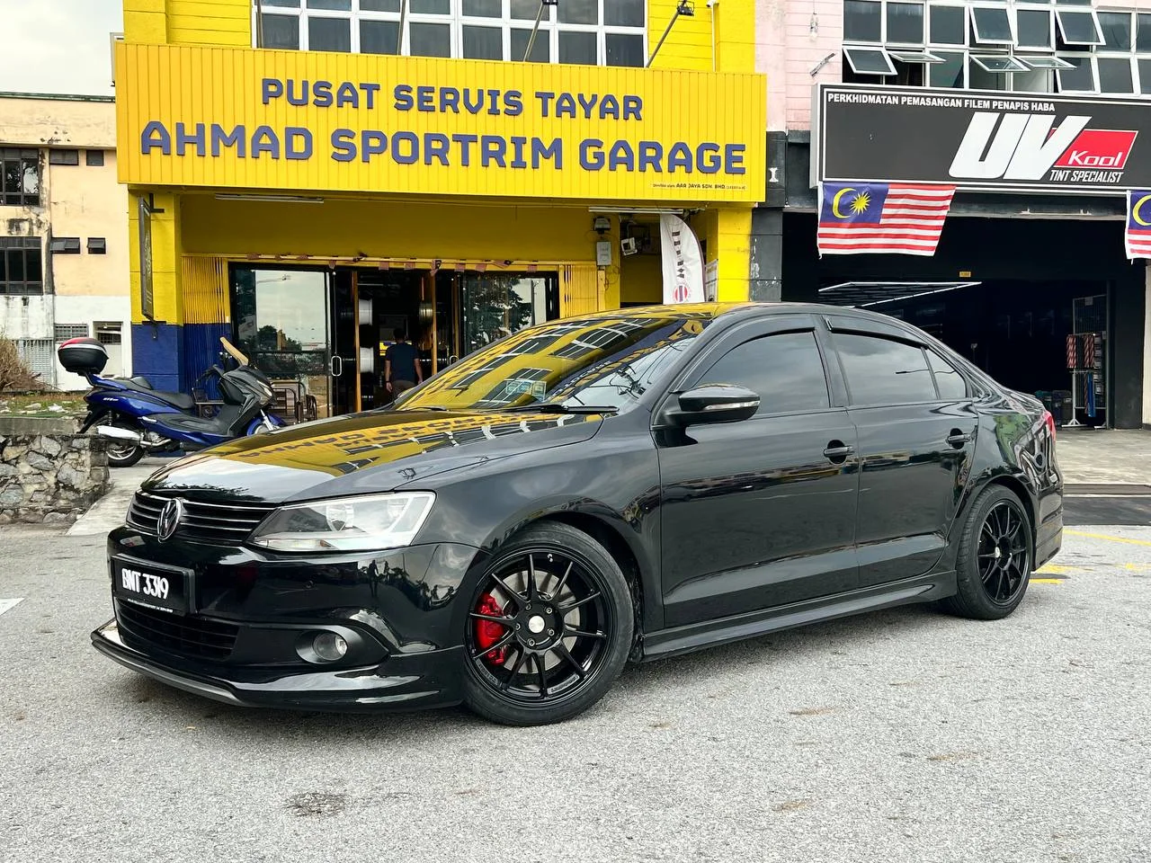 Black Volkswagen Jetta with black multi-spoke wheels outside ASG