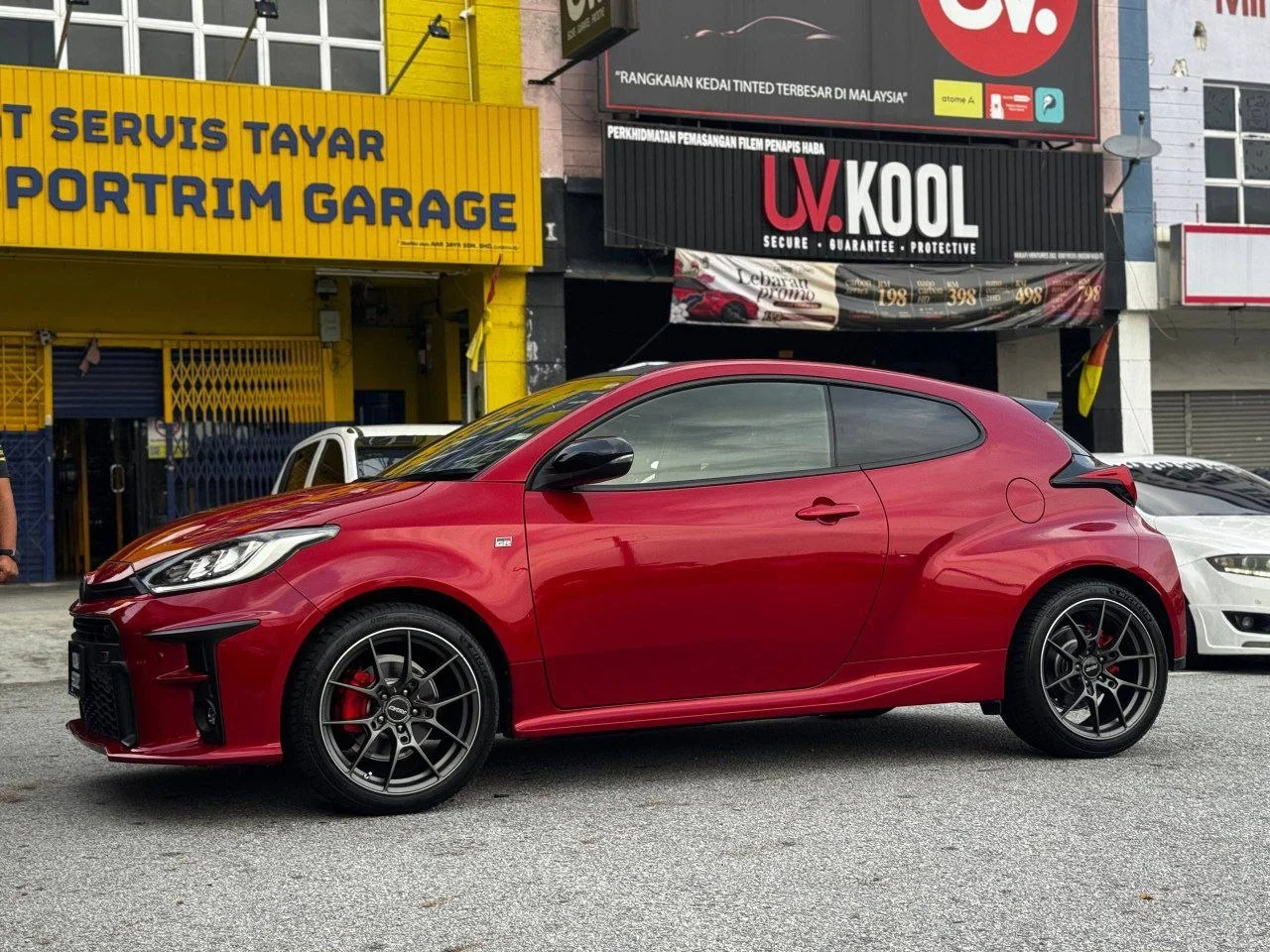 Red Toyota GR Yaris with dark multi-spoke wheels outside ASG