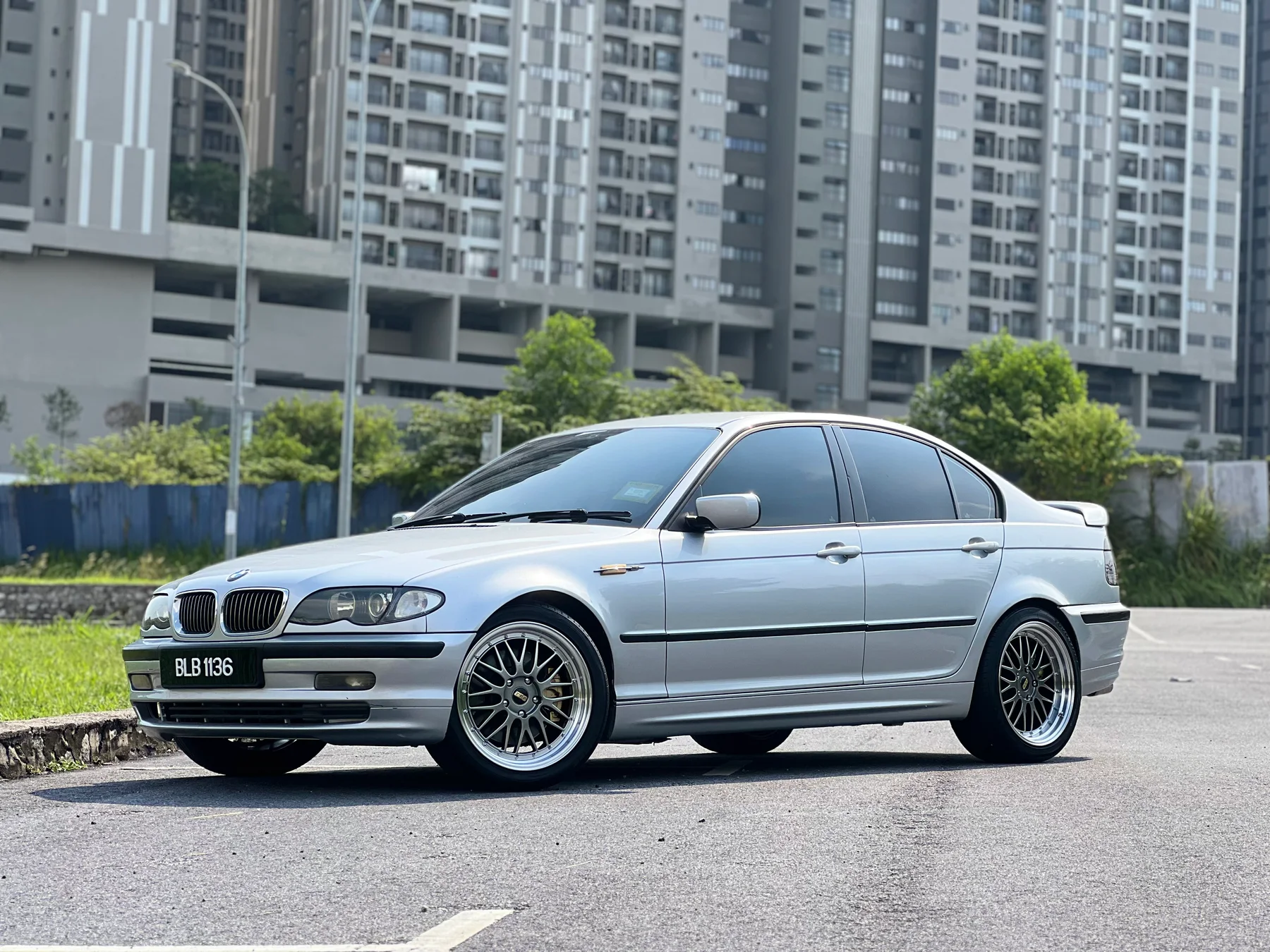 Silver BMW 3 Series sedan with polished mesh wheels
