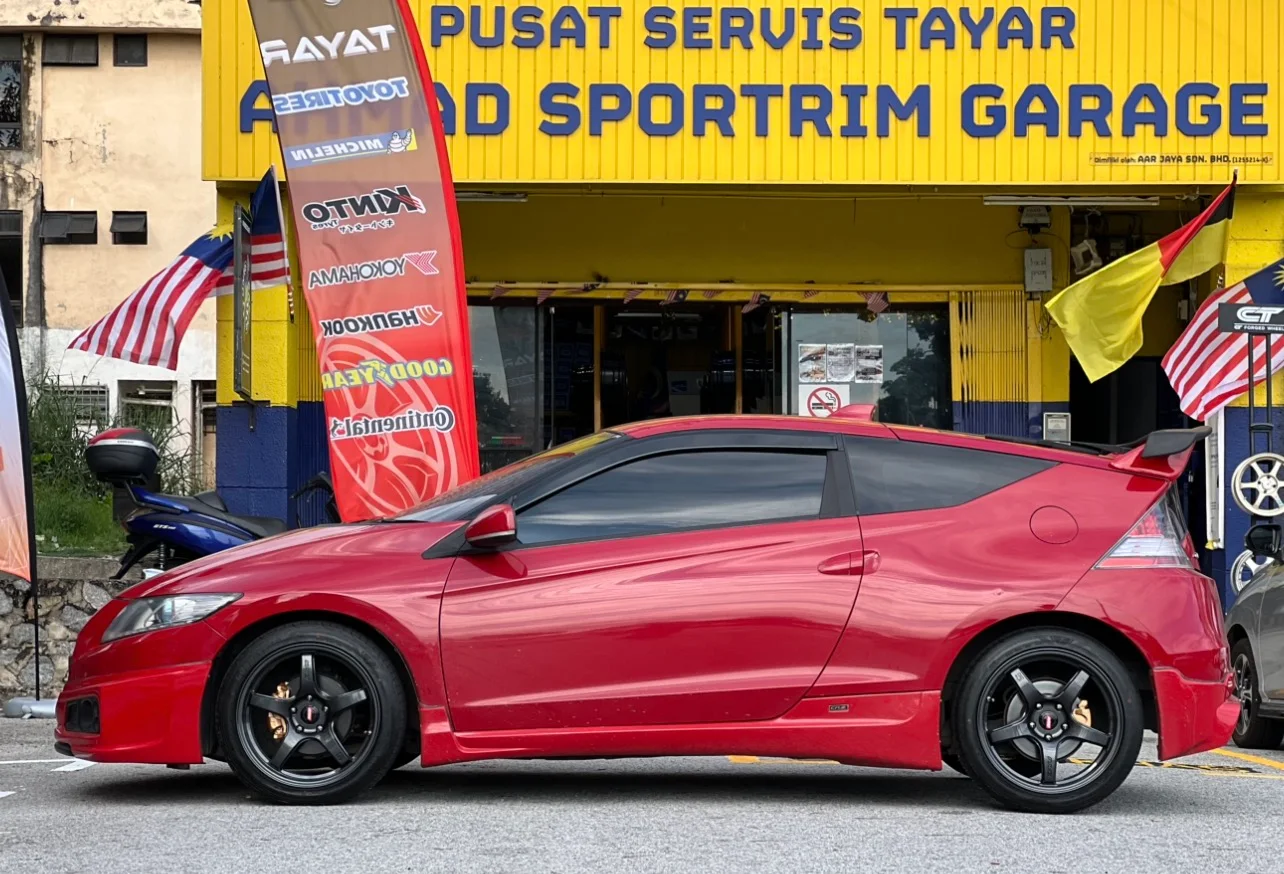 Red Honda sedan with dark performance wheels outside ASG