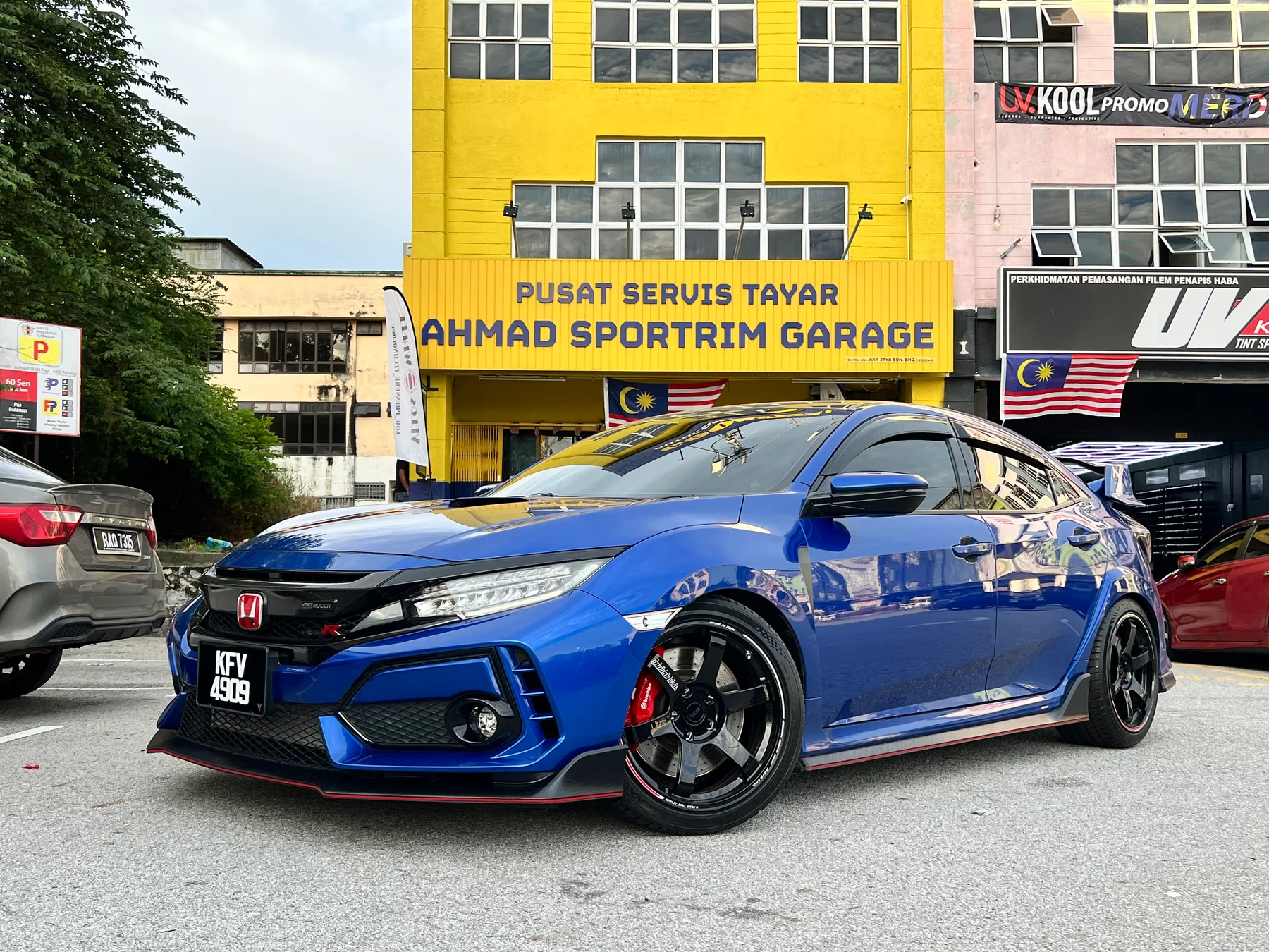 Blue Honda Civic Type R with black performance wheels outside Ahmad Sportrim Garage