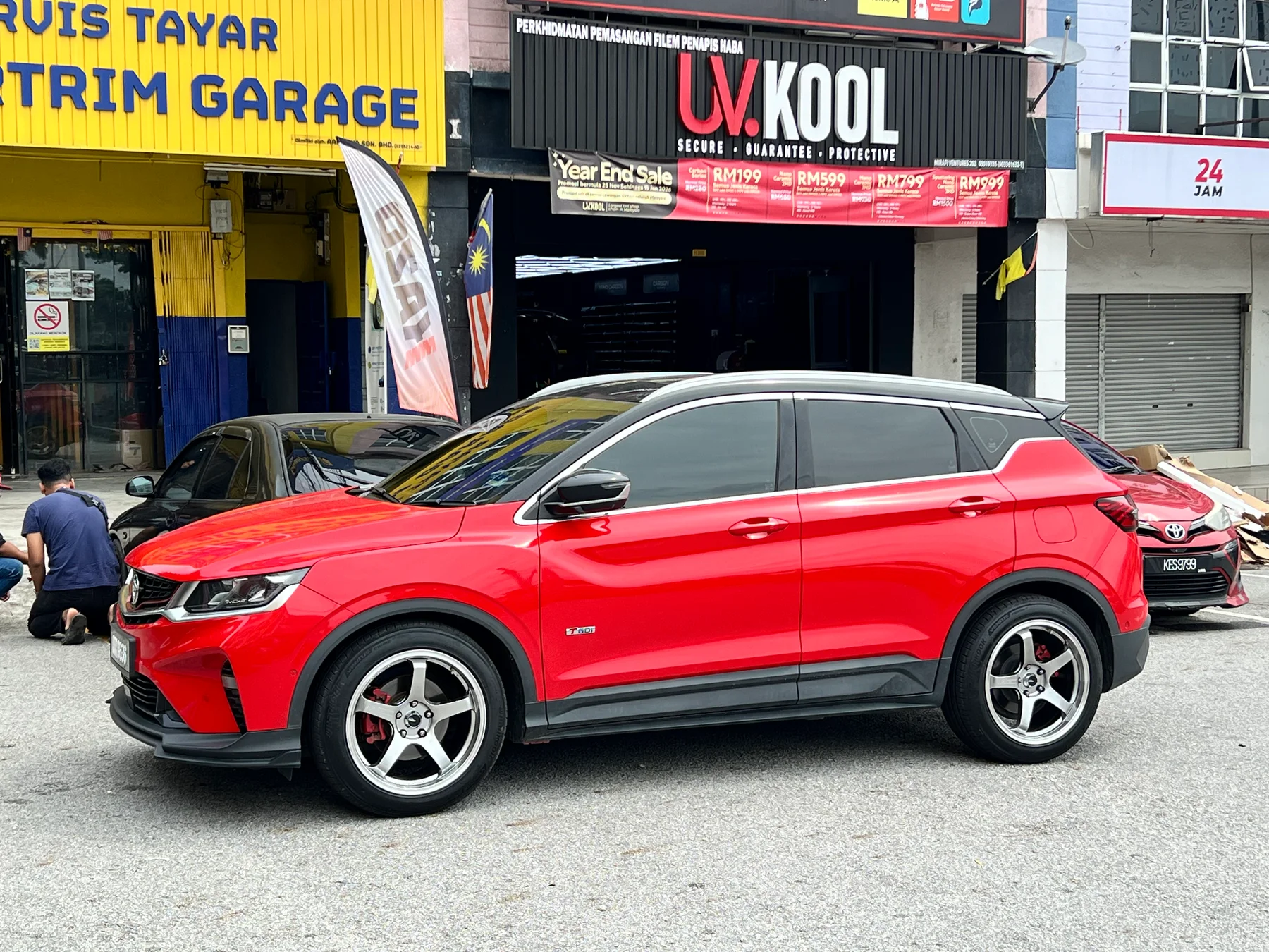 Red Proton SUV with silver five-spoke wheels outside ASG