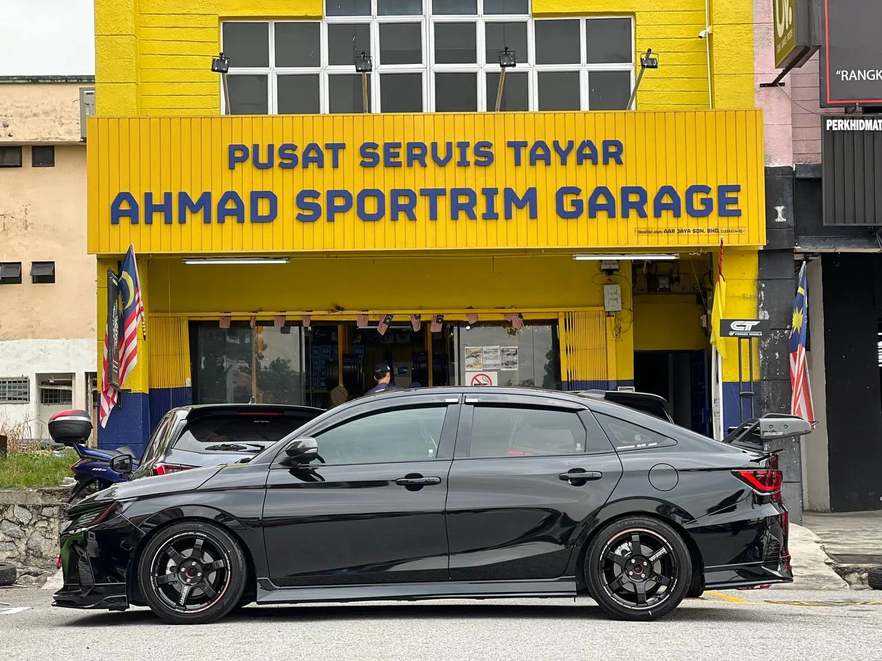 Black Toyota Vios with dark performance wheels outside ASG